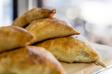 A tray of pastries with sesame seeds on top