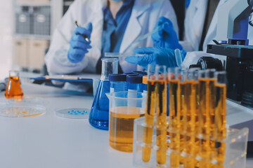 Collaboration, tablet or science with people in lab together for research or development. Innovation, tech and microscope with scientist team in clinical trial for planning or medical investigation