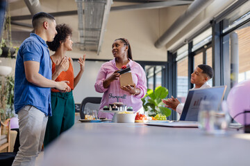 Colleagues celebrating farewell with cake and gifts in modern office setting