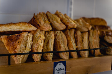 Various fresh and delicious pies and buns are on counter