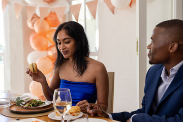 Smiling couple sharing joyful moments and meal at wedding celebration together