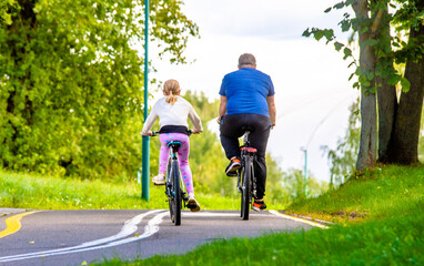 Cyclists ride on the bike path in the city Park

