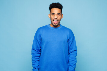 Young sad angry mad indignant dissatisfied man of African American ethnicity wearing sweatshirt...