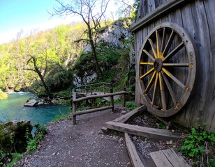 Fototapeta premium Wooden structure beside a river in a lush forest