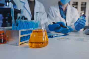 Collaboration, tablet or science with people in lab together for research or development. Innovation, tech and microscope with scientist team in clinical trial for planning or medical investigation