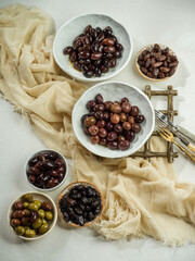 Various greek olives over a white background