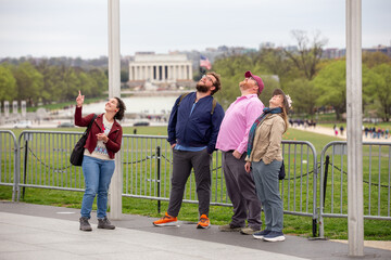 A group of friends looking up at the Washington Monument