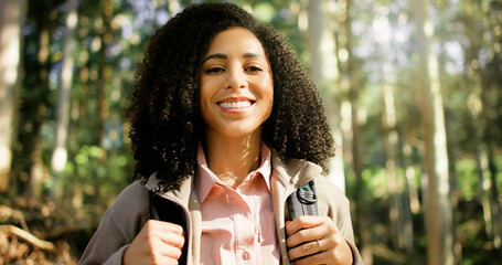 Happy woman, portrait and forest with backpack for hiking, adventure or explore outdoor wilderness. Female person, hiker or smile with bag or trees in nature for trekking journey or travel in woods