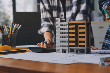 Construction and structure concept of engineer working drawing on blueprint meeting for project...