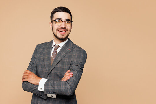 Fototapeta Side view young successful employee business man corporate lawyer wear classic formal grey suit shirt tie glasses work in office look aside on area isolated on plain beige background studio portrait.