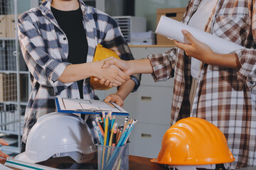 Construction and structure concept of engineer working drawing on blueprint meeting for project working with partner on model building and engineering tools in working site, construction concept.