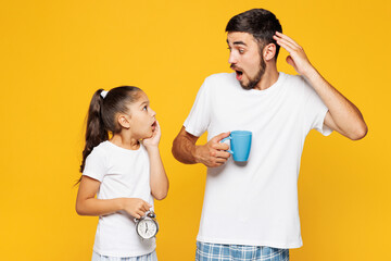Young sad parent man with child girl wear casual blue pyjamas clothes. Daddy little kid daughter...