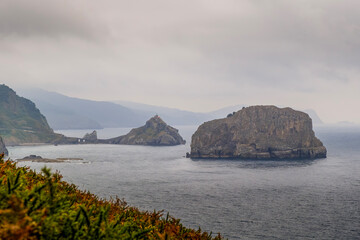 San Juan De Gaztelugatxe View From Cape Machichaco Lighthouse Basque Coast. Rocky Outcrops, Atlantic Ocean, Game Of Thrones Location, Northern Spain