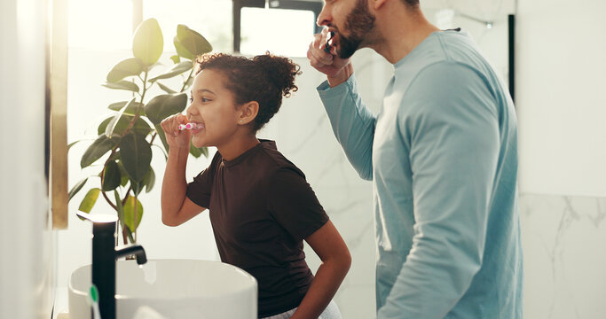 Happy child, dad and brushing teeth in bathroom for dental hygiene or morning routine in home. Father, daughter and toothbrush with mirror or lens flare for clean mouth, fresh breath or oral care