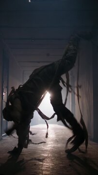 Scary Halloween mummy dancer in costume showing breakdance freestyle in haunted corridor with flickering ceiling light spooky cinematic atmosphere horror party cosplay entertainment scary celebration