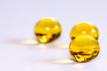 Yellow transparent capsules on a piece of textile material.