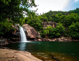 Waterfall cascading into a tranquil pool surrounded by lush greenery