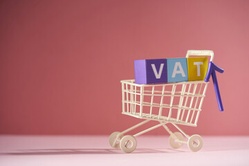 shopping cart and toy block with text VAT