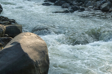 Large rocks on the edge of a mountain river. Can be used for advertising product placement design. For graphic design, 3D rendering and banner backgrounds