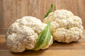 Cauliflower on wooden background. Vegetable for cooking.
