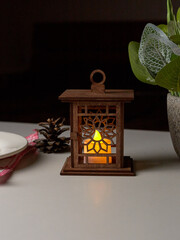 Decorative lantern with a burning candle, glowing at night