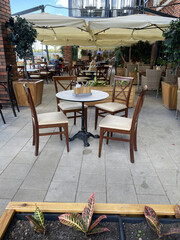 Outdoor cafe tables with chairs are in the general interior