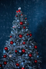 Christmas tree decorated with toys on a blue background