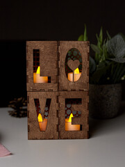A candle holder in the form of the word love