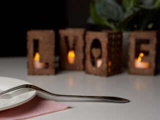 A candle holder in the form of the word love for design