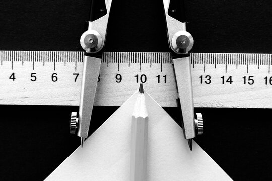 Still life with a compass, wooden measuring ruller and pencil	