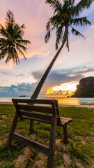 Tropical beach sunset with bench