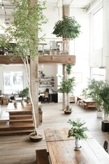 Bright open interior with wood beams. Trees grow throughout expansive space. Tables and chairs sit near plants. Light streams in through large window.