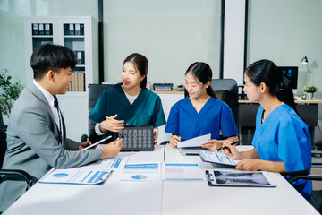 Fototapeta premium Doctors, nurses, and consultant review anatomy data on tablet and lab reports in a modern clinic. Healthtech, diagnostics, teamwork, and medical collaboration.