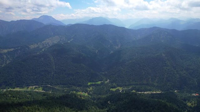 4K Aerial drone video of Tegernseer H&uuml;tte, incredible cabin nested in the mountains between Ro&szlig;stein and Buchstein peaks in German Alps with beautiful nature surrounding Leonhardstein on a sunny day