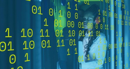 IT technician in white shirt red headset checking controls in DC aisle, binary overlay, copy space