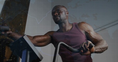 Pedaling muscular man wearing maroon tank top, gripping bike handlebars, adjusting console in gym