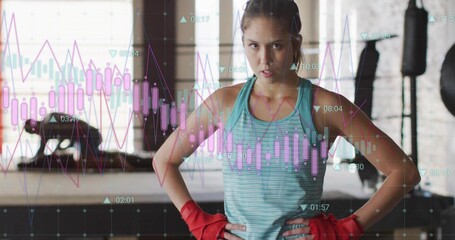 Standing White woman wearing turquoise top with red wraps at gym, with financial chart overlays