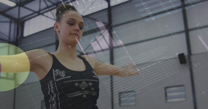 Fototapeta Balancing teenage athlete wearing black tank top extending arms in gymnasium, with digital overlays