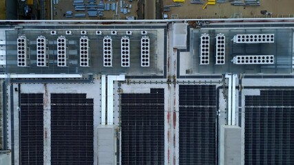 Top down aerial view of data centre cooling fan turbines, air conditioning and solar panels on roof, industrial building and information technology - Powered by Adobe