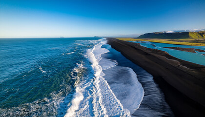 Aerial View of Black Sand Beach with Crashing Waves and Blue Ocean image photo