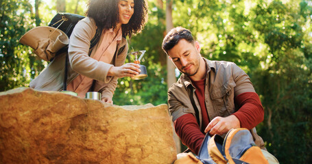 Couple, hiking and help with camping stove, unpack or coffee preparation on holiday. Trekking, man and woman with portable cooking equipment in bag, travel gear and happy interracial people in woods