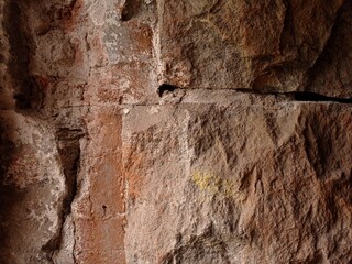 Close up of an old rough, stony wall.