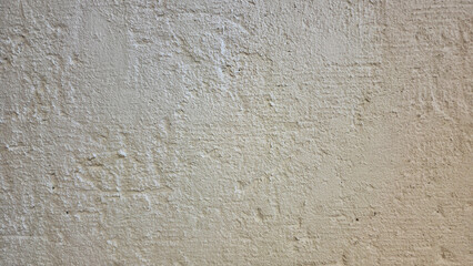Rough textured beige plaster wall