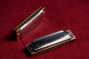 harmonica on a red background, close-up.