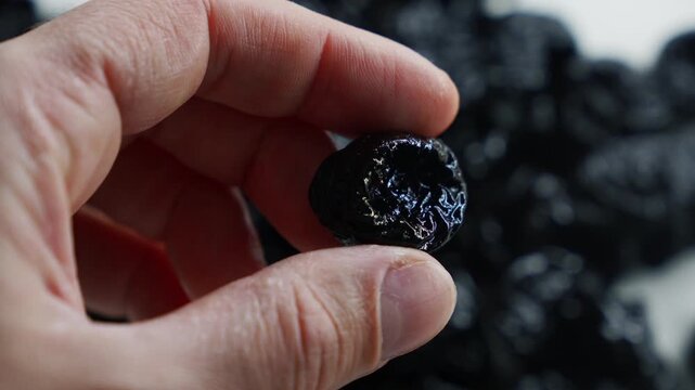 Fresh and healthy prunes.
Close-up of prunes on a plate.
A healthy and delicious fruit.
Dried plums for treating flatulence and constipation.