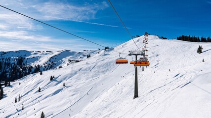 Discover the beauty of winter sports in Austria with a picturesque ski lift ascending a snow-covered mountain. Perfect for travel promotions and showcasing the charm of the Austrian Alps.