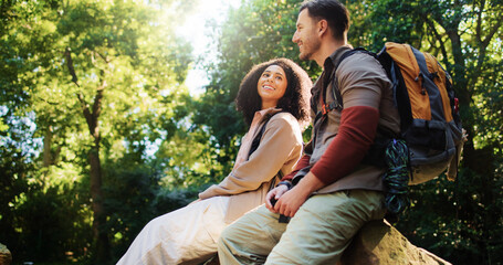 Happy, hikers and couple in nature, relax and break on adventure, forest or love on holiday or trip. Outdoor, people and bonding on journey, backpacking and smile on vacation, traveller and woods
