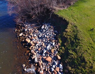 Riverbank with rocks and grass