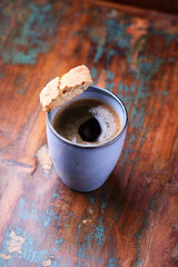 Pizza with ham, salami, cherry tomatoes and mozzarella cheese. Rustic wooden background. Soft focus. Close up.	
