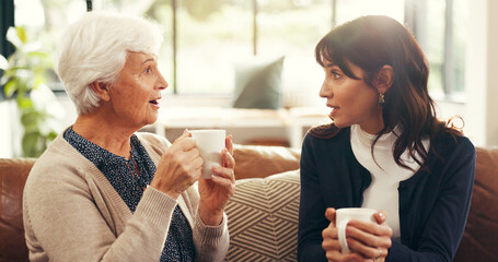 Senior, mother and daughter with coffee in home for gossip story, bonding or weekend visit on sofa. Family, women or relax in living room with wow conversation, tea and morning reunion for connection